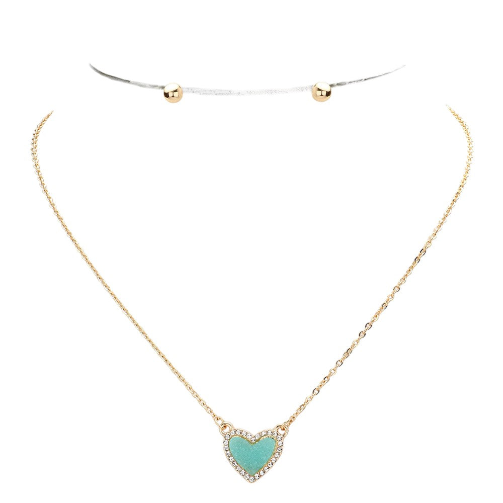 Aqua Rhinestone-Trimmed Druzy Heart Pendant Necklace adds sparkle and elegance to any outfit. The rhinestone trim enhances the natural beauty of the druzy heart pendant, creating a stunning and sophisticated look. Perfect for adding a touch of glamour to your wardrobe