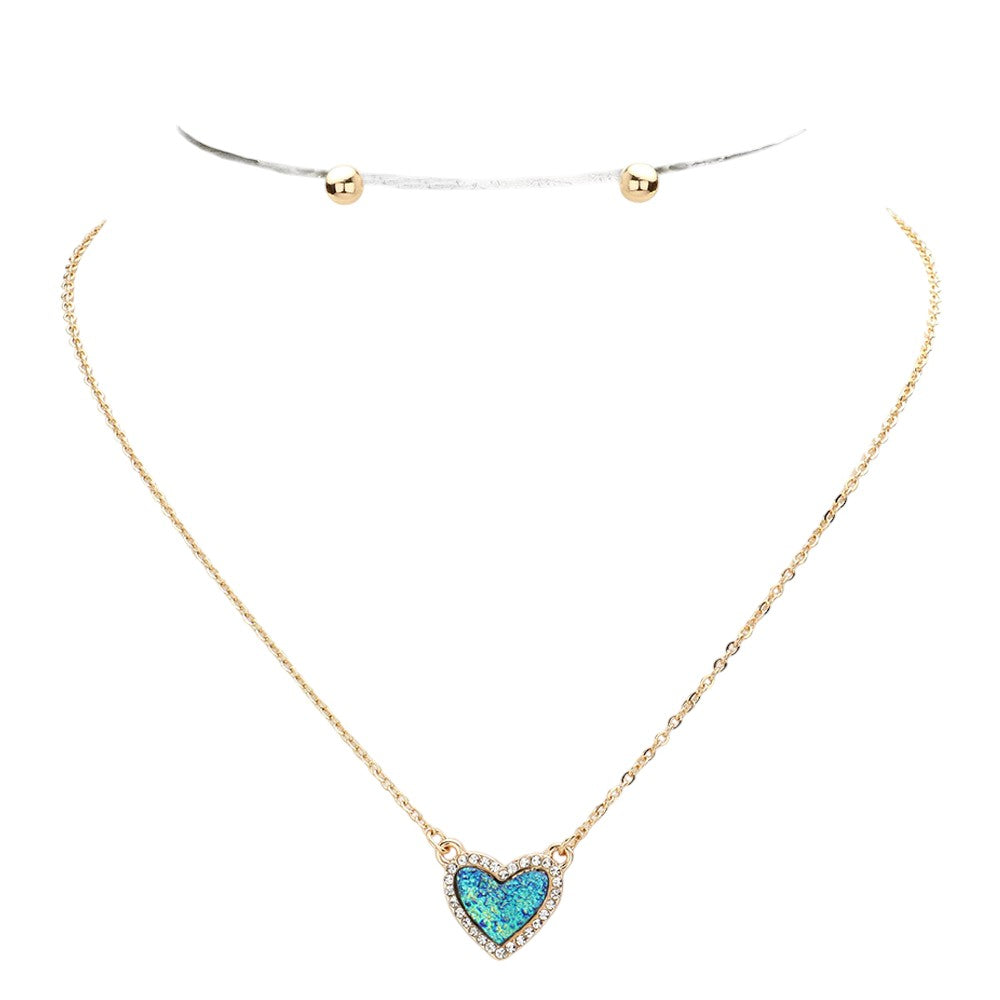 Blue Rhinestone-Trimmed Druzy Heart Pendant Necklace adds sparkle and elegance to any outfit. The rhinestone trim enhances the natural beauty of the druzy heart pendant, creating a stunning and sophisticated look. Perfect for adding a touch of glamour to your wardrobe