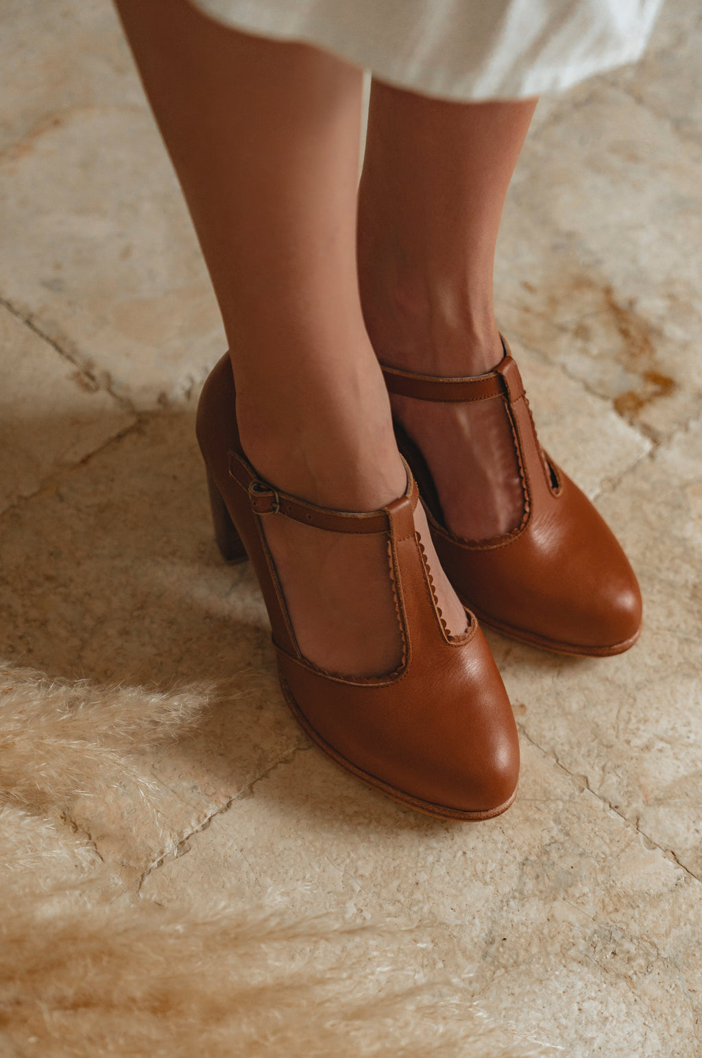 Brown shoes worn on a stone floor