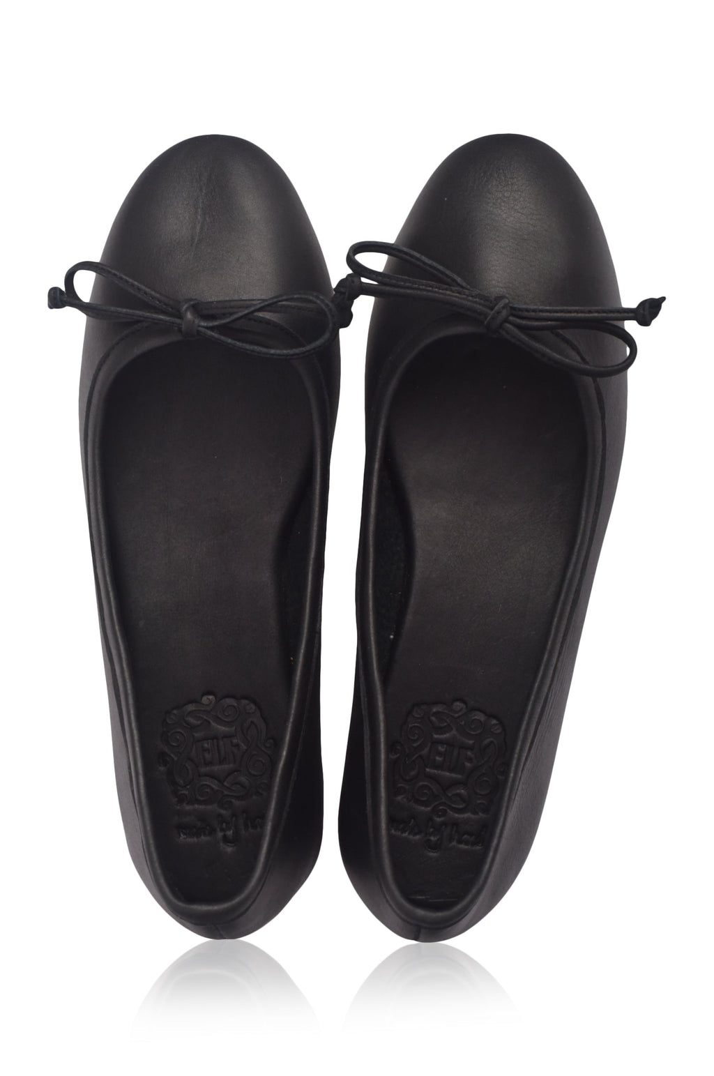 Pair of black flat shoes with bow details on a white background