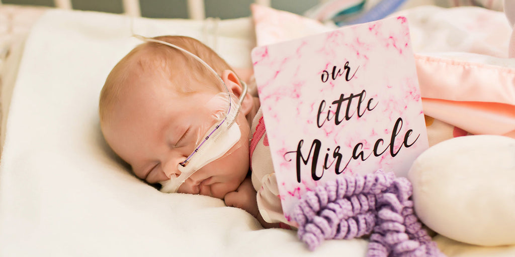 Three Little Tots NICU Milestone card next to a Premature baby girl in the NICU