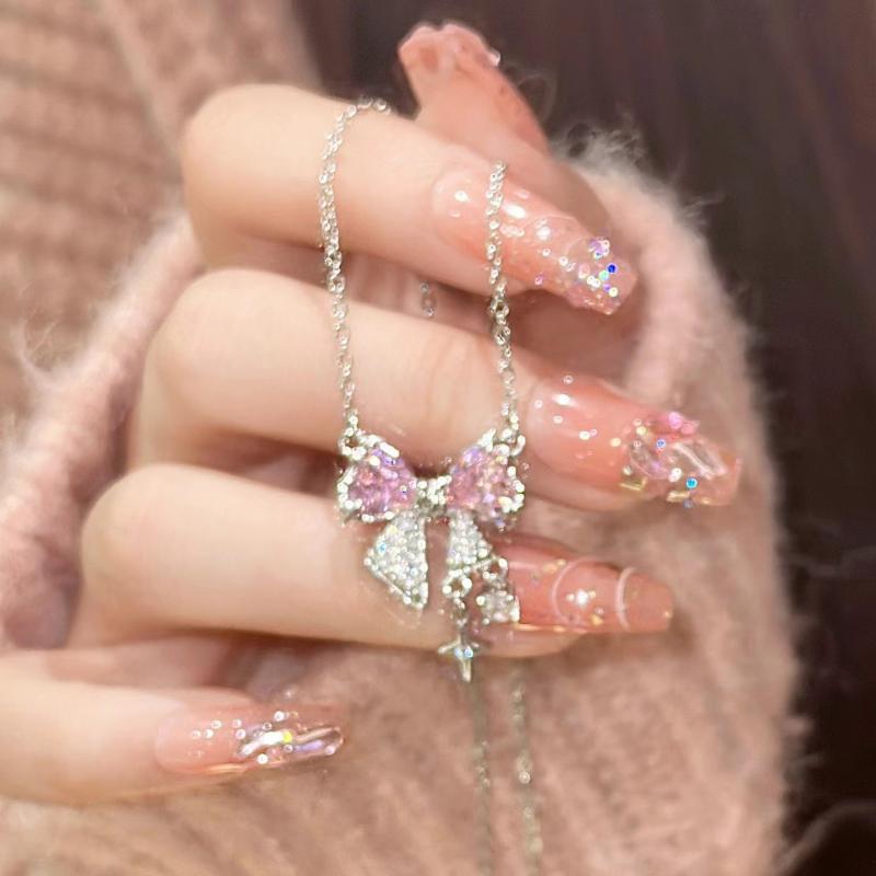 Model Holding Kawaii Pink Bow Pendant Necklace