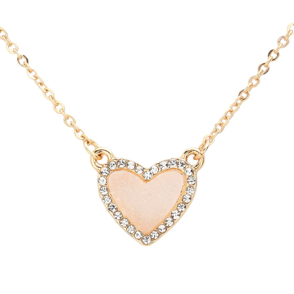 White Rhinestone-Trimmed Druzy Heart Pendant Necklace adds sparkle and elegance to any outfit. The rhinestone trim enhances the natural beauty of the druzy heart pendant, creating a stunning and sophisticated look. Perfect for adding a touch of glamour to your wardrobe