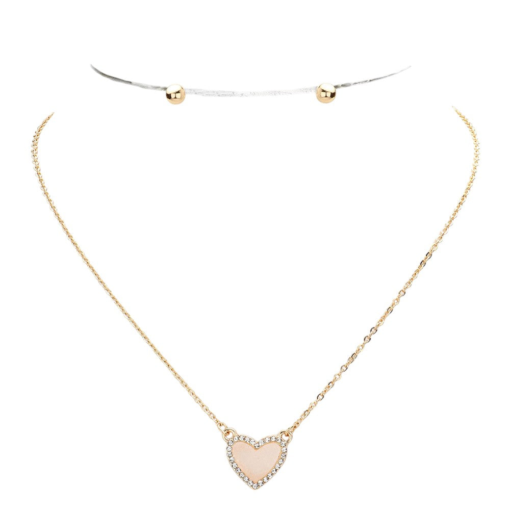 White Rhinestone-Trimmed Druzy Heart Pendant Necklace adds sparkle and elegance to any outfit. The rhinestone trim enhances the natural beauty of the druzy heart pendant, creating a stunning and sophisticated look. Perfect for adding a touch of glamour to your wardrobe