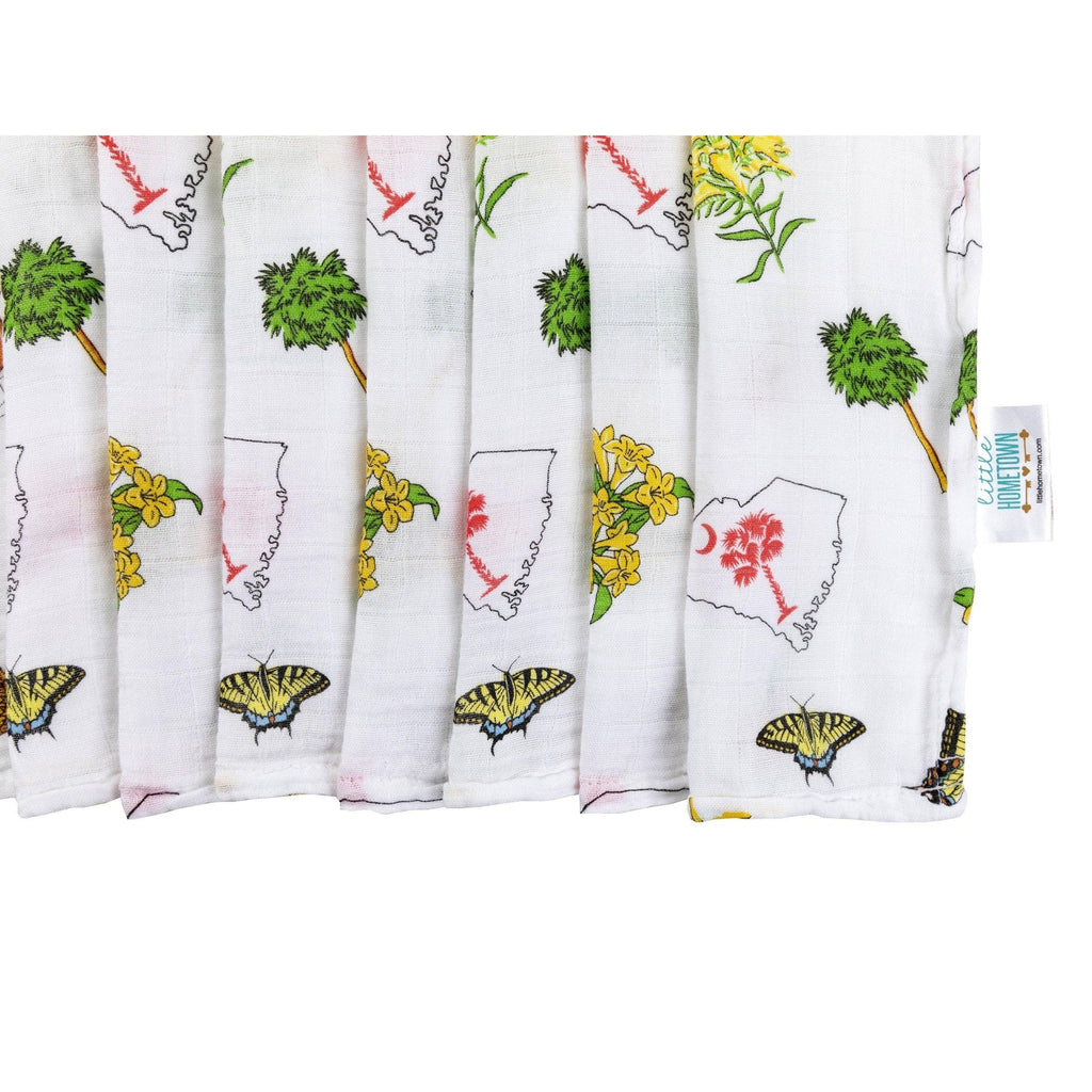 South Carolina-themed baby gift set with muslin swaddle blanket and burp cloth/bib combo, featuring state icons.