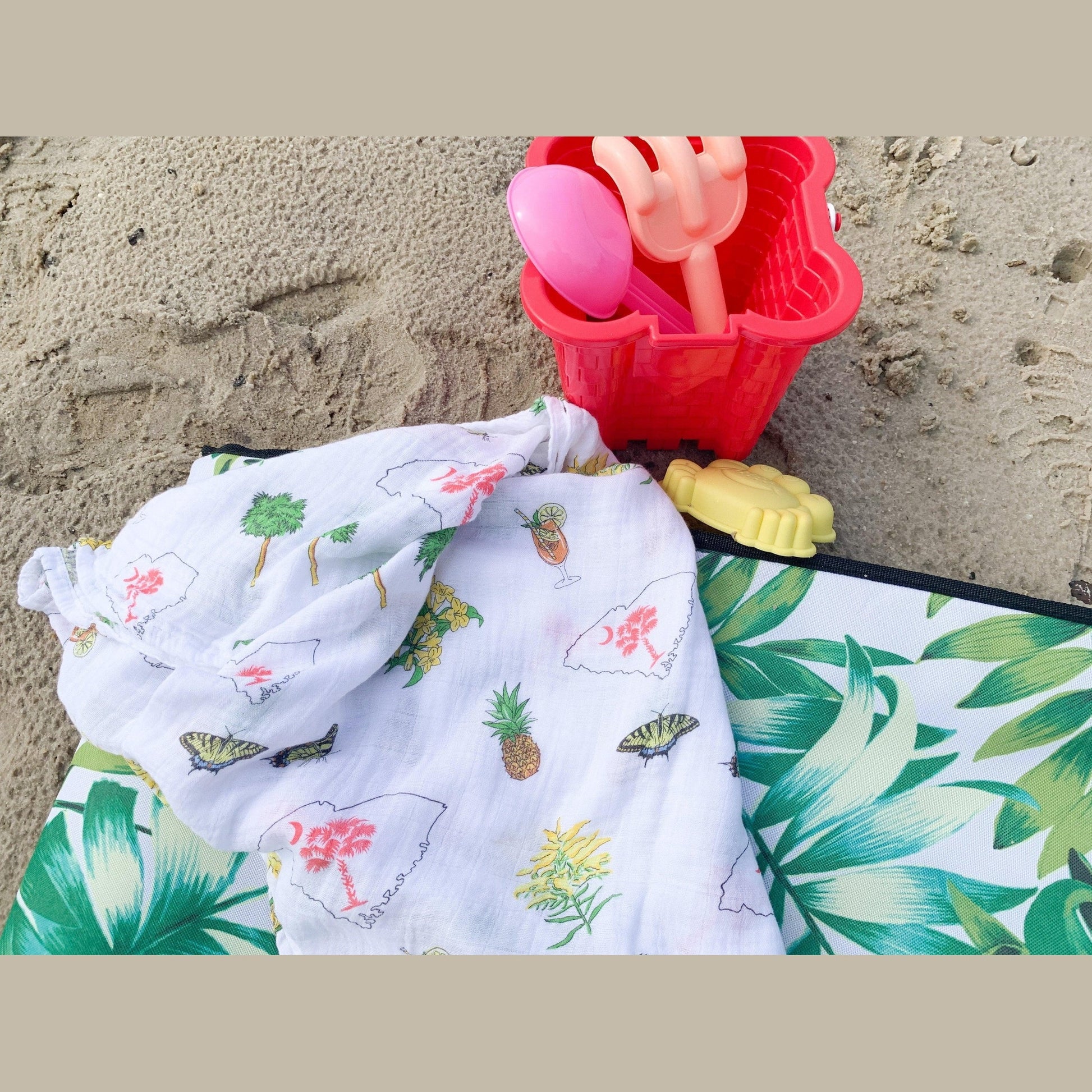 South Carolina-themed baby gift set with muslin swaddle blanket and burp cloth/bib combo, featuring state icons.